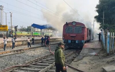 Railway workers try to douse the fire after a fire broke out at the…